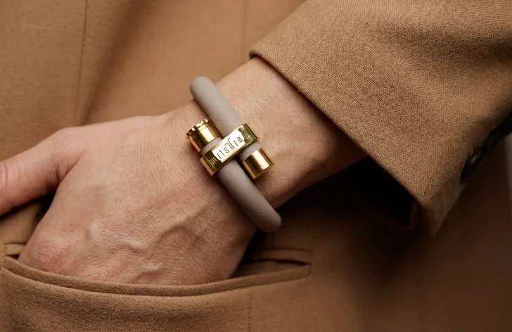 wristraw in Stone Taupe with a Gold clasp, worn on the wrist